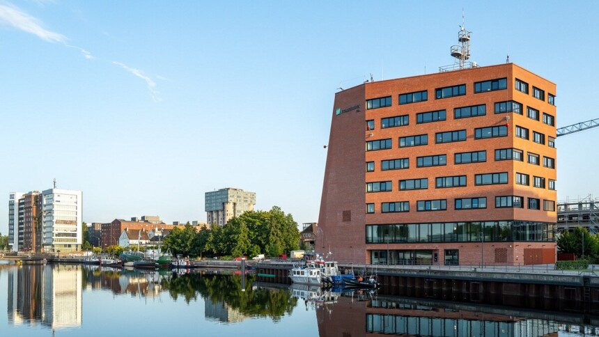 Idyllic seaport ambience with modern new building in the background