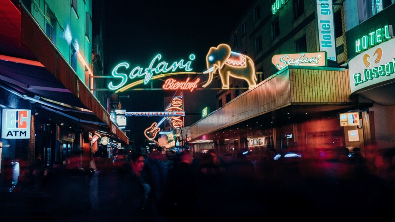 Reeperbahn at night with neon lights and crowds  