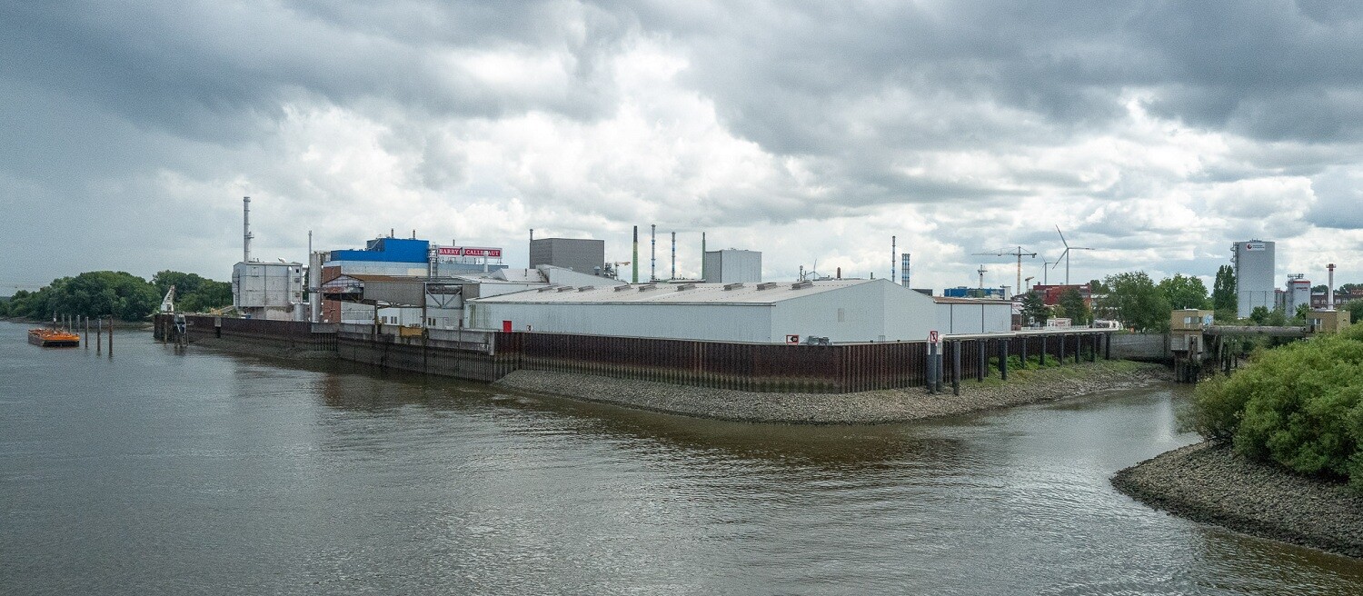 Large industrial site located directly on the water's edge