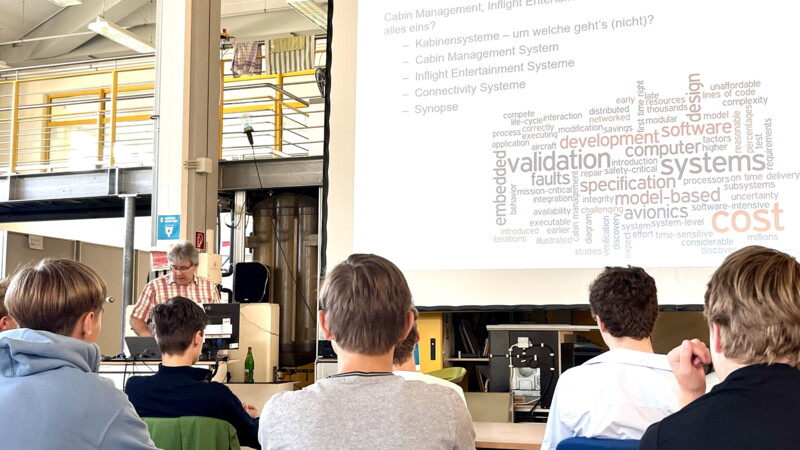 Young people listen to a talk on cabin management and software during YOTA‘ss Summer Camp