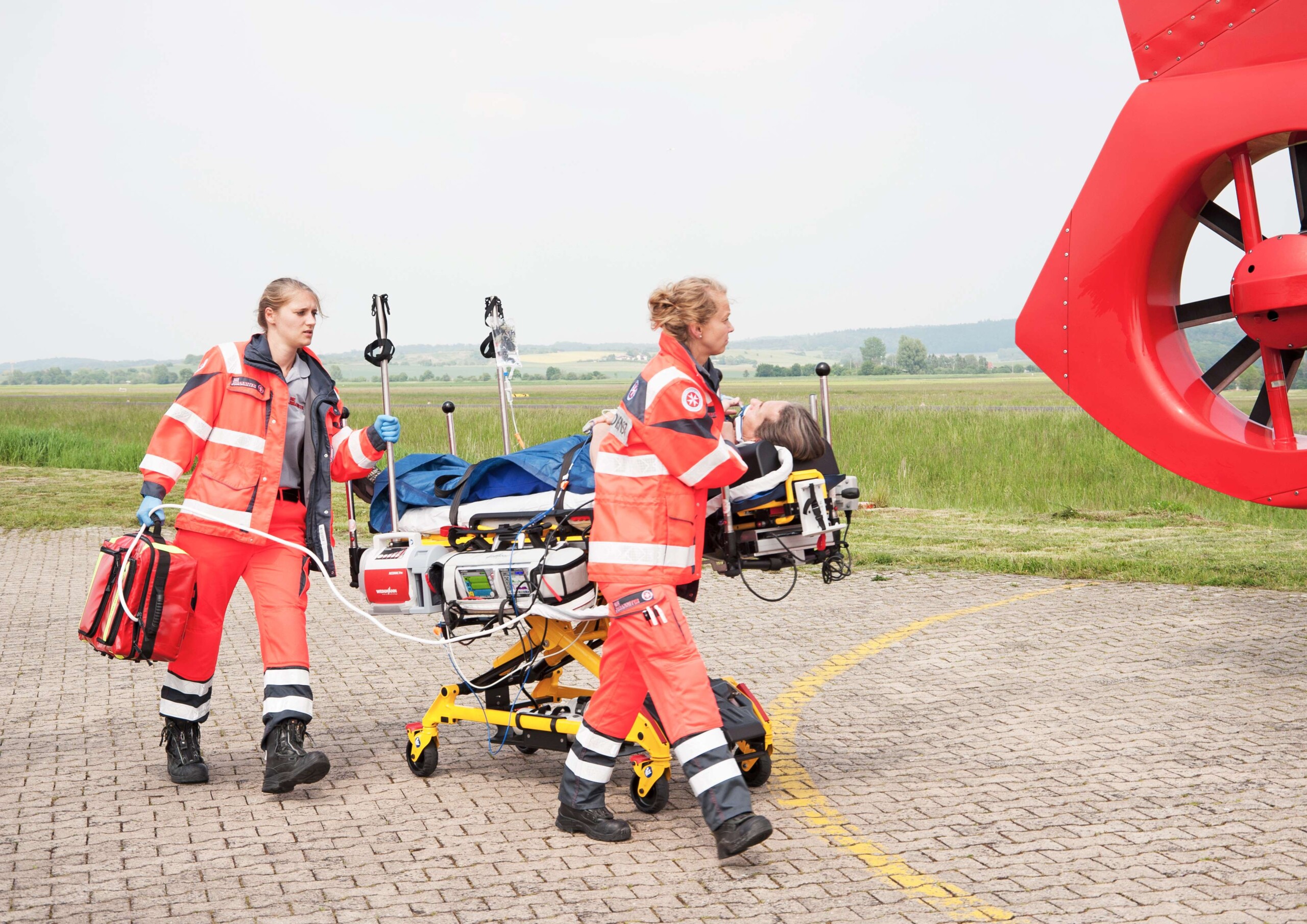 Paramedics with an injured person heading to rescue helicopter