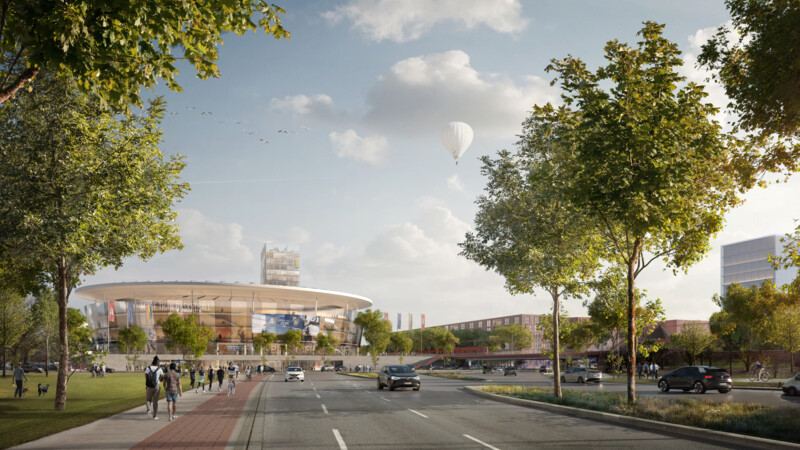 Modern circular sports arena with people walking, cars on road, trees, and a hot air balloon in the sky.