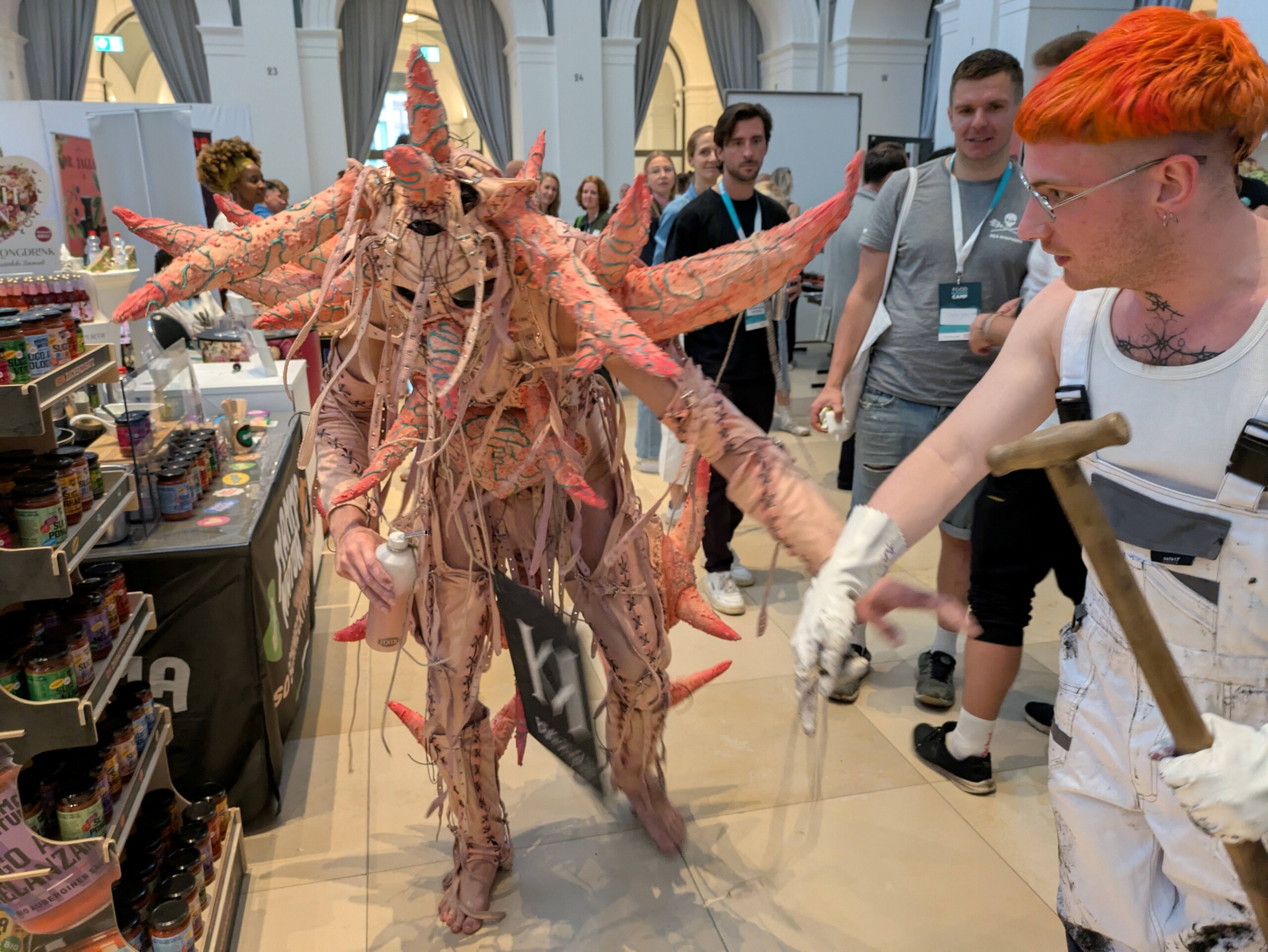 An orange monster is herded through FIC's exhibition