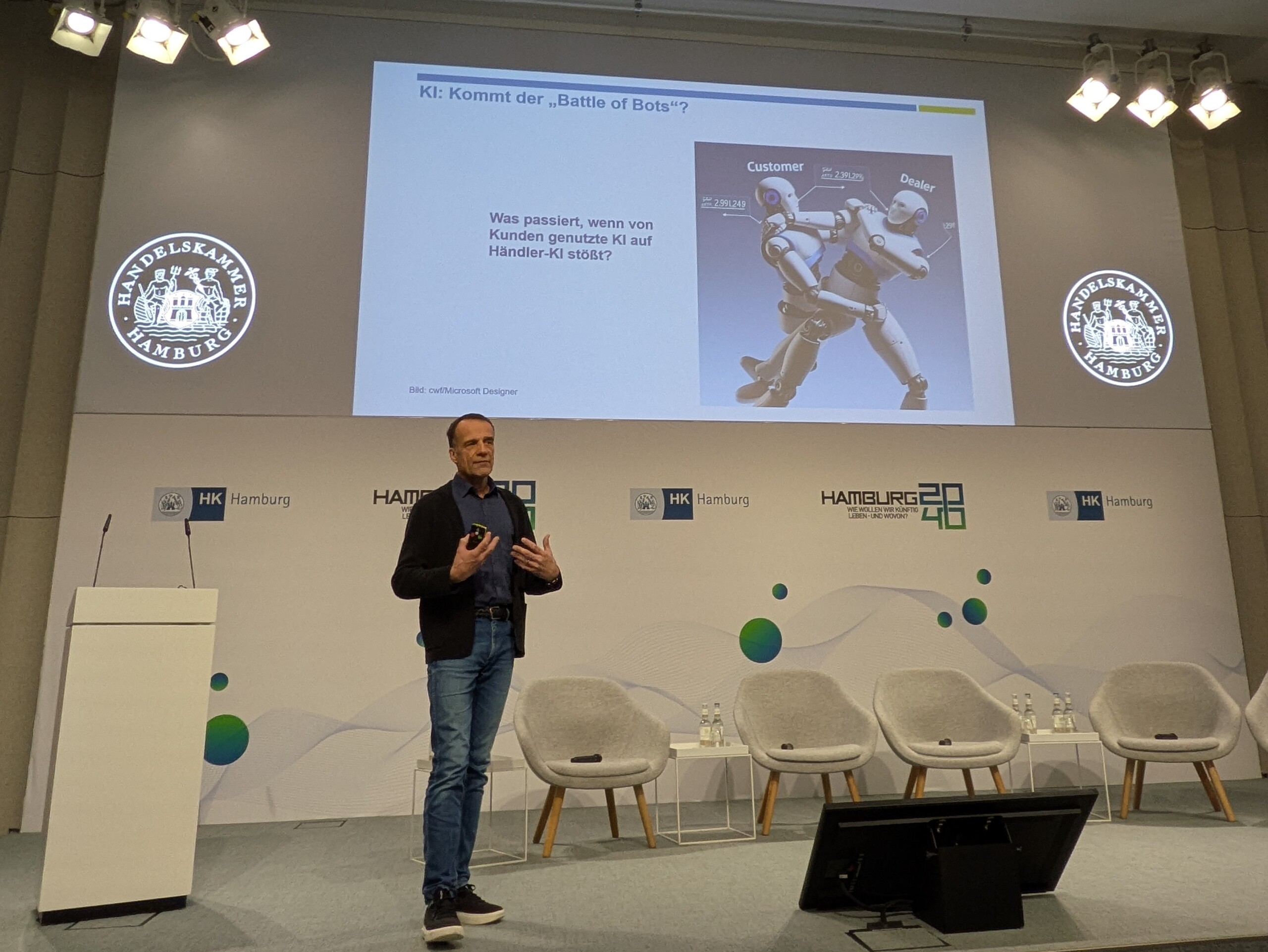 Christoph Wenk-Fischer in front of a slide showing two wrestling AI bots