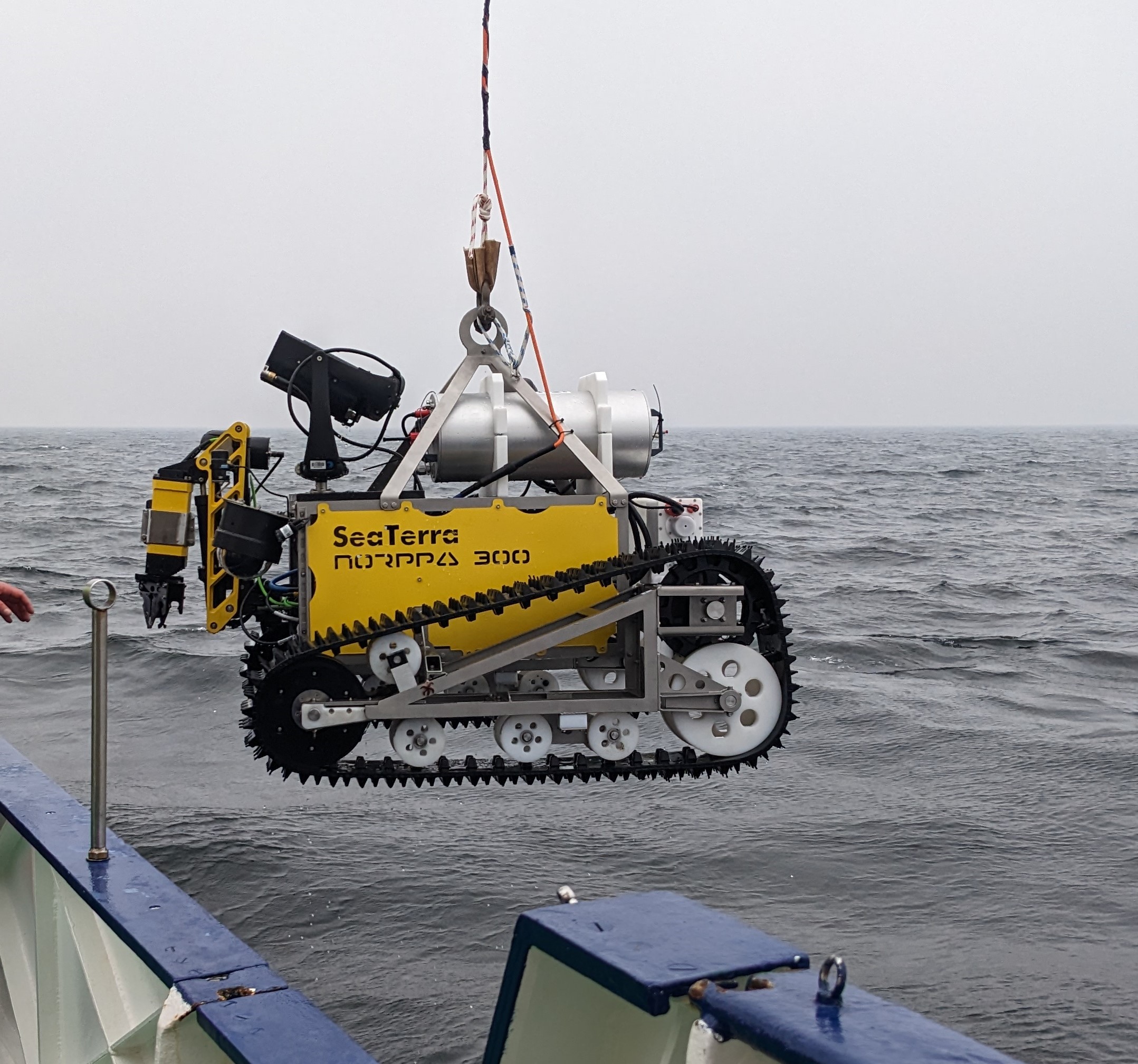 Underwater robot for recovering small-arms ammunition is lowered into the sea