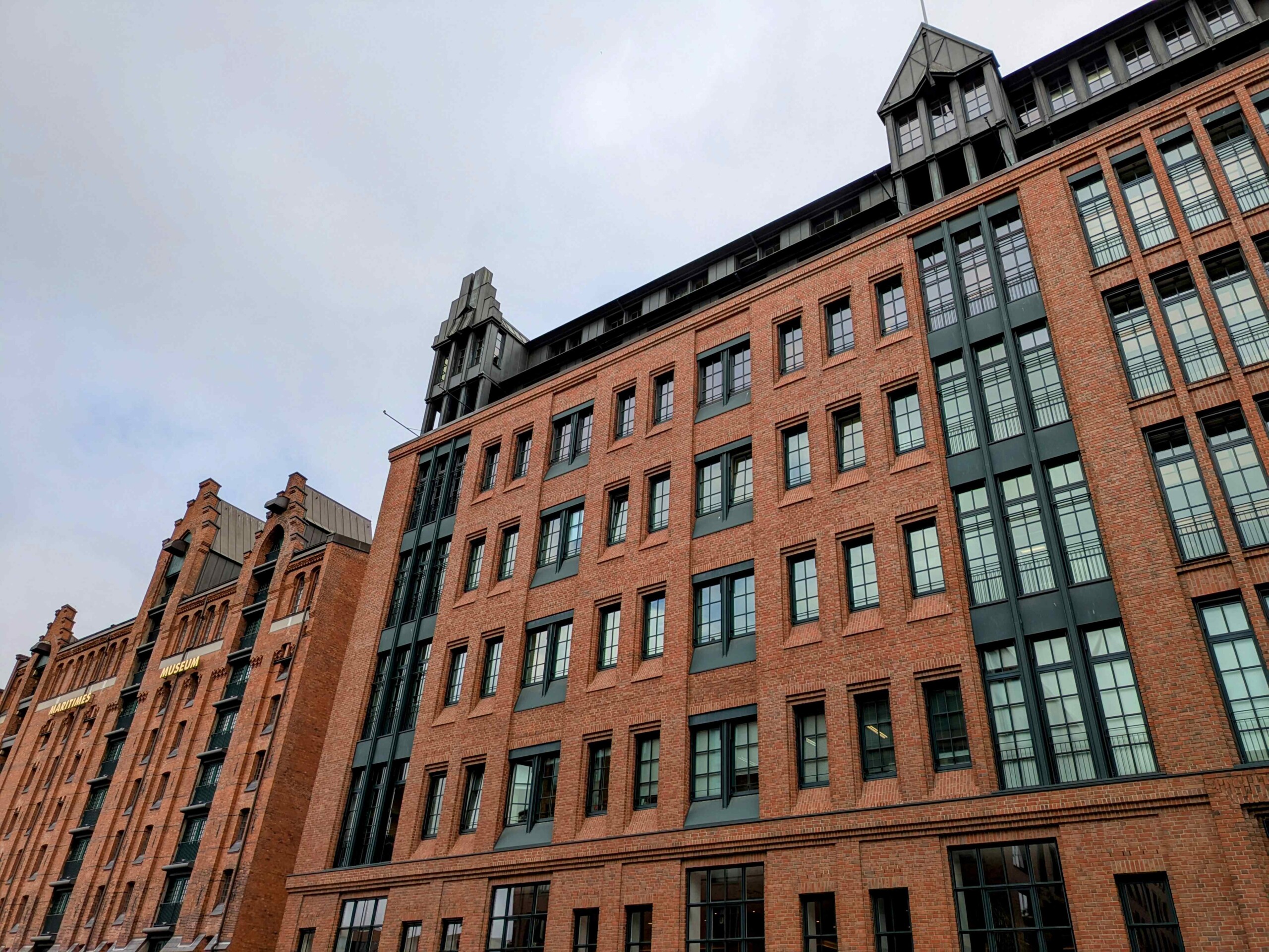 Facade of a historic red brick building with lots of windows