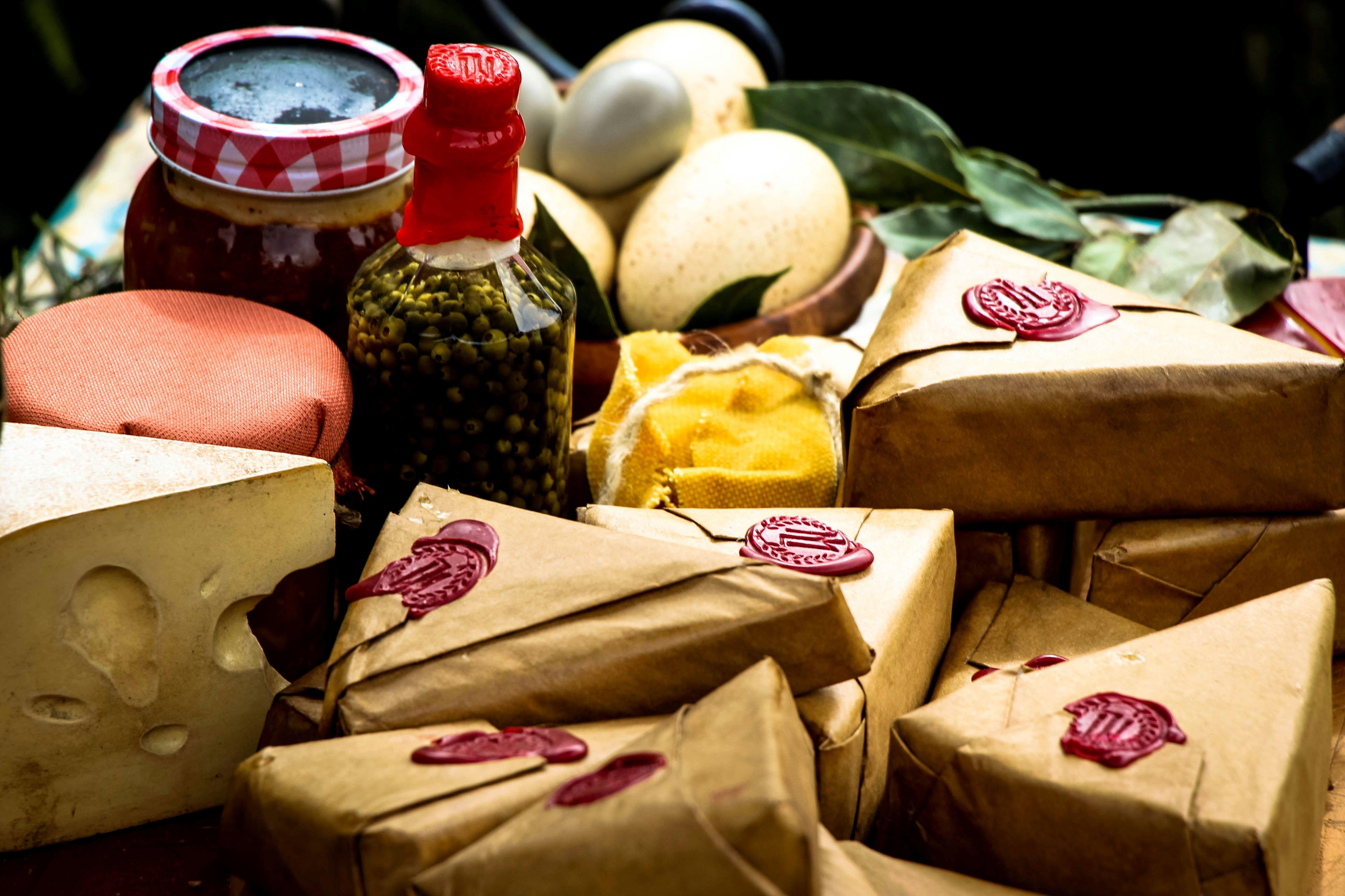 Picture shows various cheeses, unpackaged and packaged, as well as preserving jars and eggs