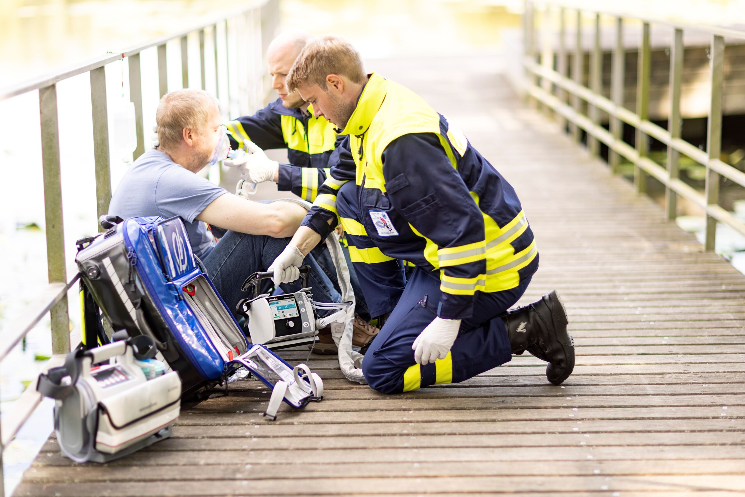 Two paramedics provide an injured person with oxygen 